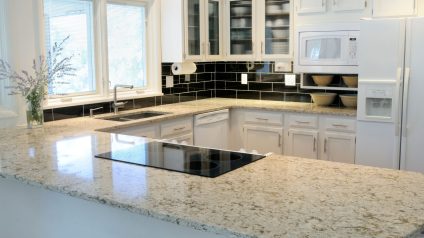 Beige granite countertops with warm white cabinets in a Chicago kitchen remodel