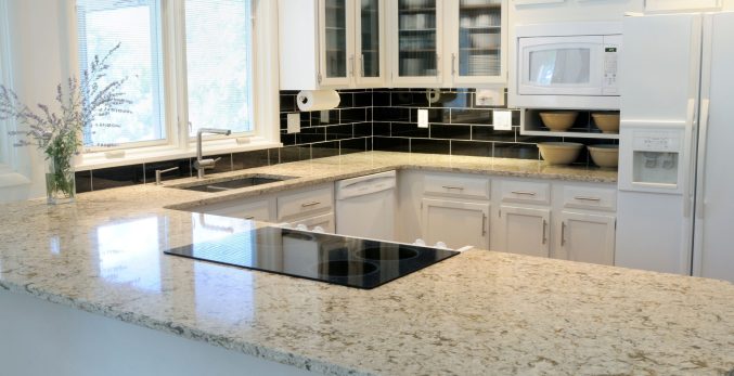 Beige granite countertops with warm white cabinets in a Chicago kitchen remodel