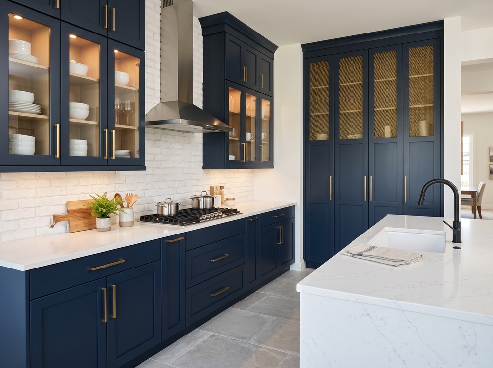 Navy blue shaker kitchen with white quartz countertops and a matching quartz island