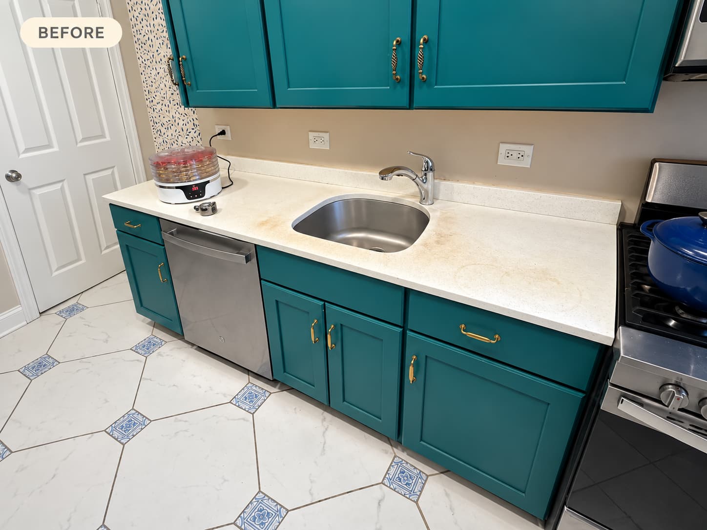 teal-kitchen-before-countertop-replacement Teal kitchen cabinets with an old cream countertop and stainless steel sink before replacement